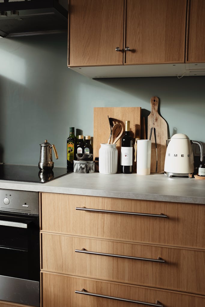 Stylish kitchen scene featuring SMEG kettle and cookware on a wooden countertop.